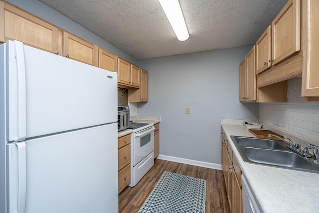 kitchen featuring white appliances, dark wood-style floors, light brown cabinetry, a sink, and tasteful backsplash