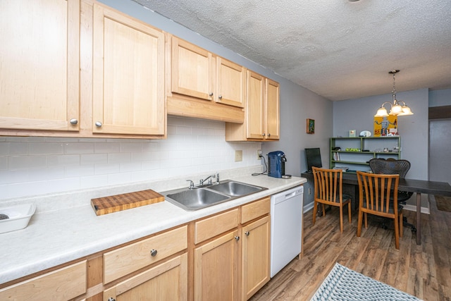 kitchen with light wood finished floors, backsplash, light brown cabinets, dishwasher, and light countertops