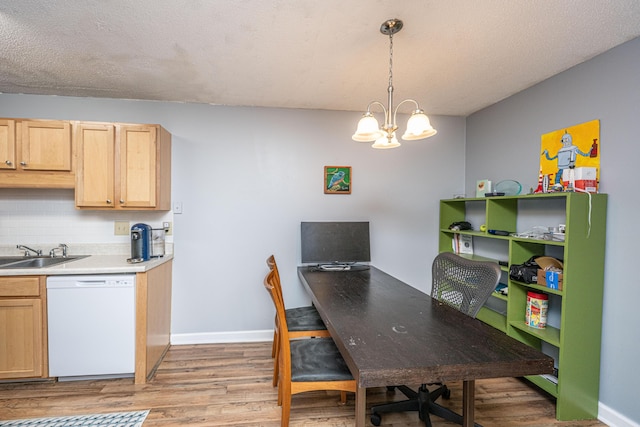 office space featuring a sink, a chandelier, baseboards, and light wood-style flooring