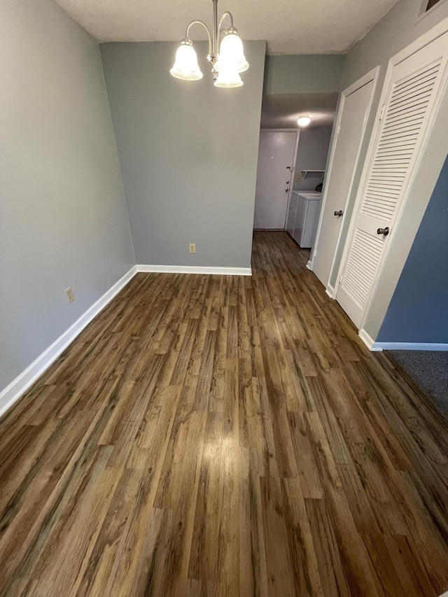 21 Rivers Point Row Unit 17B, Charleston, SC 29412 - unfurnished dining area with a chandelier, dark wood finished floors, baseboards, and washer and clothes dryer