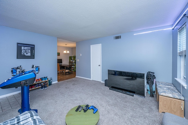 recreation room with visible vents, baseboards, carpet, a chandelier, and a textured ceiling