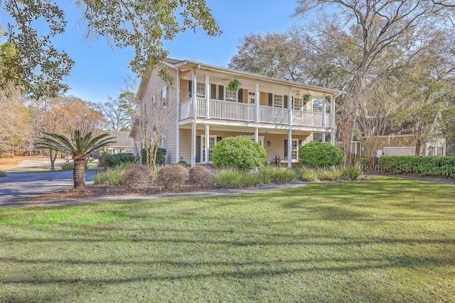 view of front of property with a front yard and a balcony