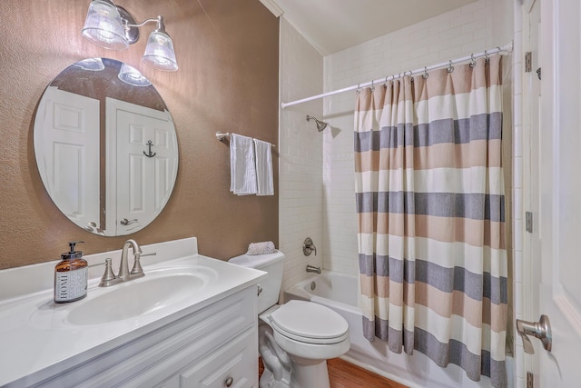 full bathroom featuring toilet, shower / bath combo, vanity, and a textured wall