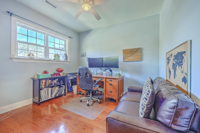 office featuring visible vents, baseboards, wood finished floors, and a ceiling fan