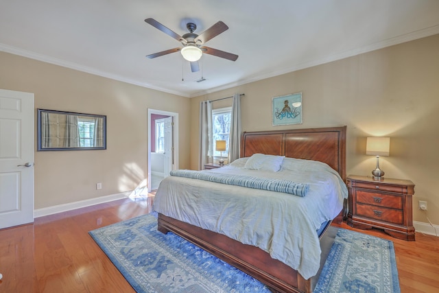 bedroom with crown molding, wood finished floors, baseboards, and ceiling fan