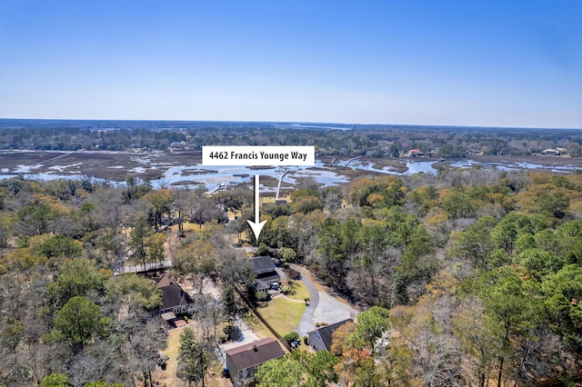 drone / aerial view with a forest view and a water view