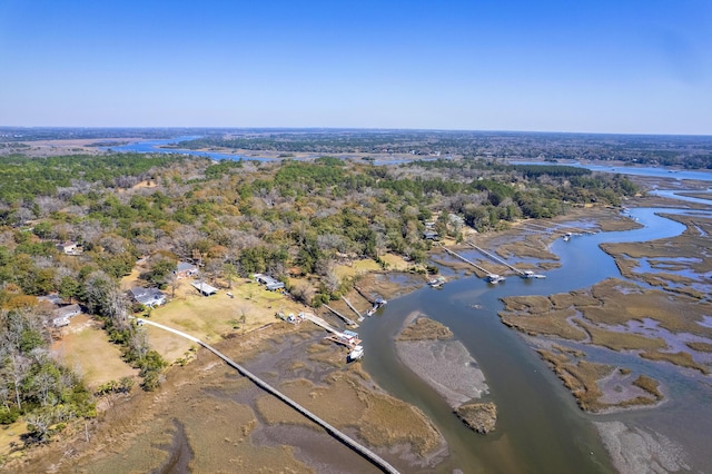 drone / aerial view featuring a water view and a wooded view