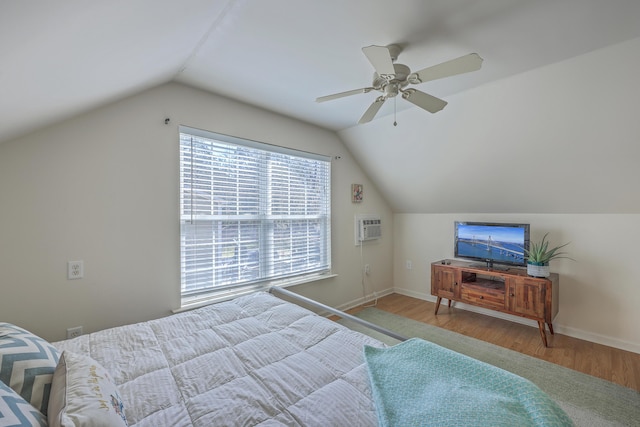 bedroom featuring baseboards, a ceiling fan, lofted ceiling, and wood finished floors