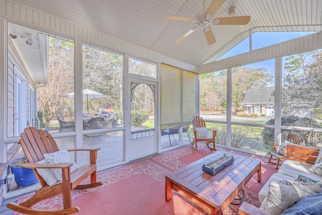 sunroom featuring a wealth of natural light, ceiling fan, and vaulted ceiling