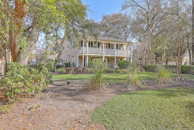 view of front of property featuring a balcony and a front lawn