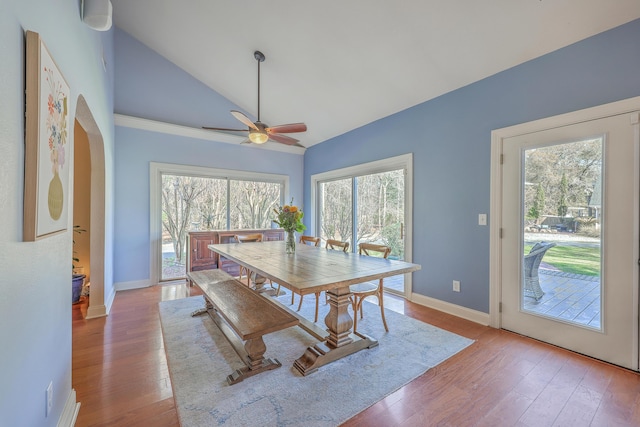 dining area with baseboards, vaulted ceiling, a ceiling fan, and hardwood / wood-style flooring