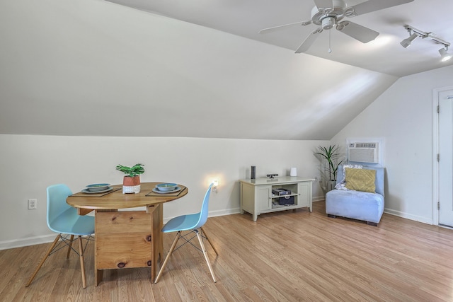 interior space featuring light wood-style flooring, a wall mounted air conditioner, lofted ceiling, and ceiling fan