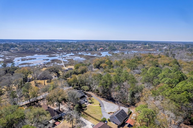 birds eye view of property with a water view and a wooded view