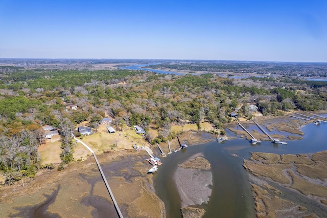 aerial view with a wooded view and a water view