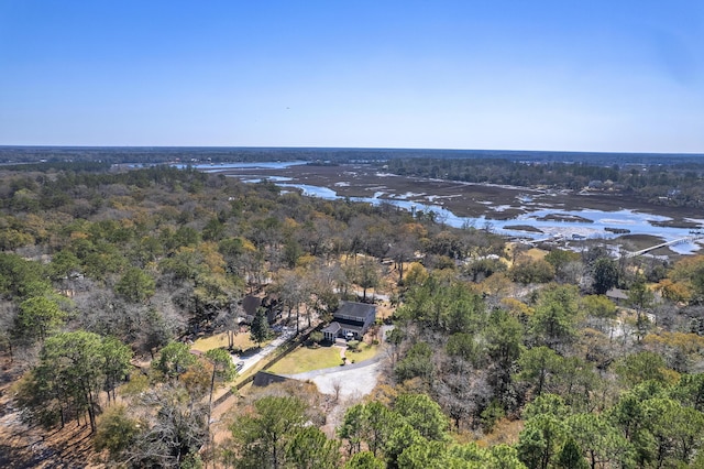 birds eye view of property with a wooded view and a water view