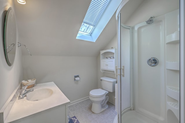 bathroom with baseboards, toilet, vaulted ceiling with skylight, a stall shower, and vanity