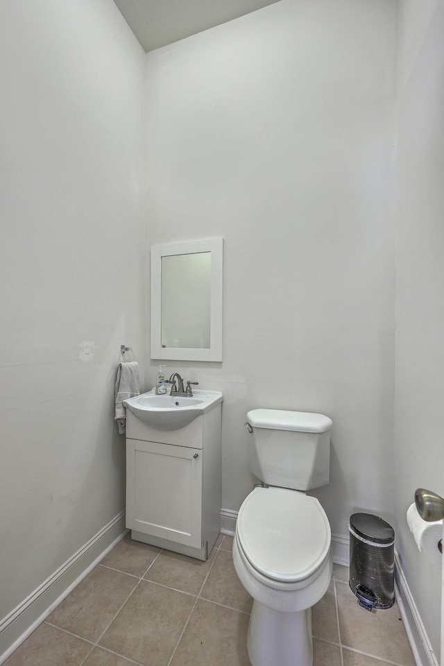 bathroom with tile patterned flooring, vanity, and baseboards