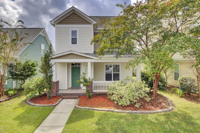 view of front of home featuring a front lawn and a porch