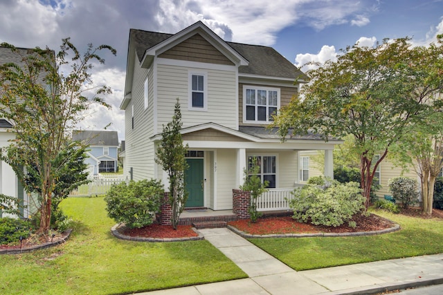 view of front facade with a front yard and a porch