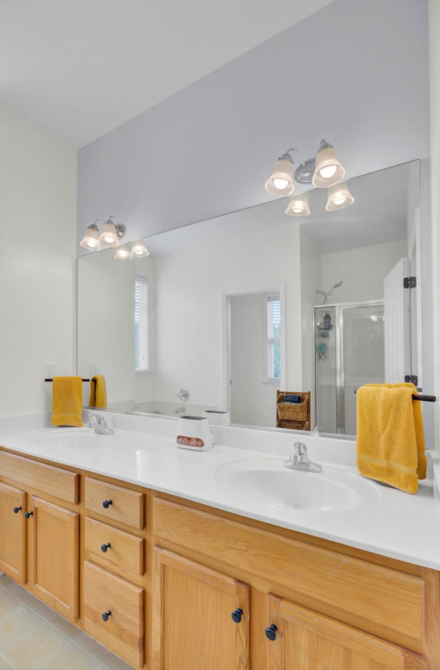 bathroom with vanity, a shower with shower door, and tile patterned flooring