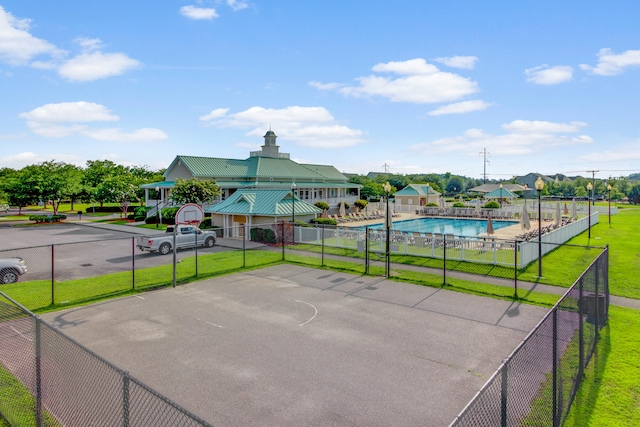 exterior space featuring basketball hoop and a community pool