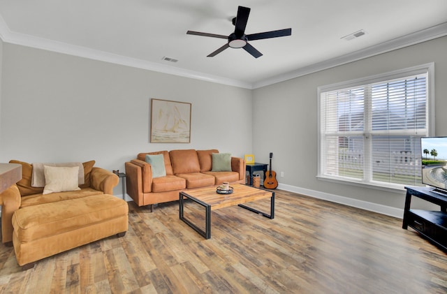 living room with ceiling fan, light wood-type flooring, and ornamental molding