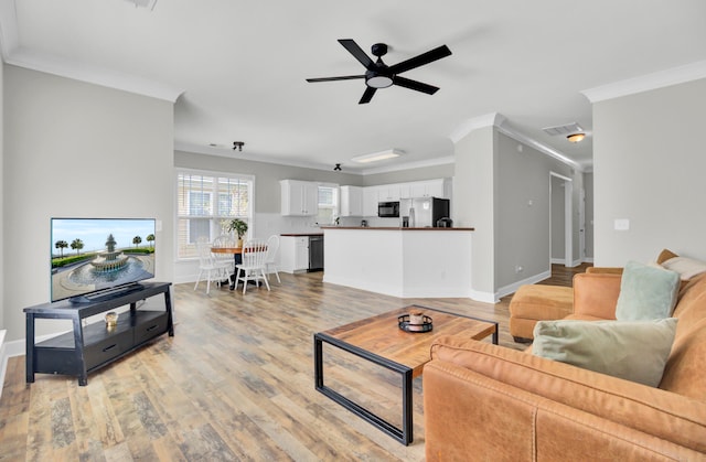 living room with ceiling fan, ornamental molding, and light hardwood / wood-style floors