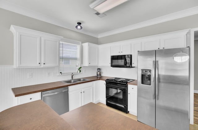 kitchen with black appliances, crown molding, sink, and white cabinets