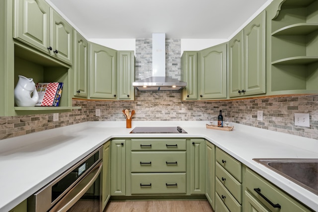 kitchen featuring open shelves, wall chimney range hood, black electric cooktop, and green cabinets