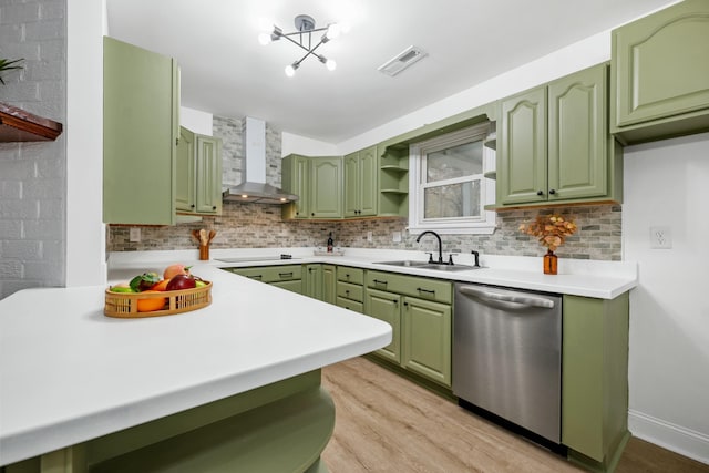 kitchen featuring dishwasher, wall chimney range hood, and green cabinets