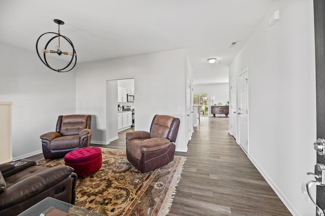 living area with visible vents, baseboards, and wood finished floors