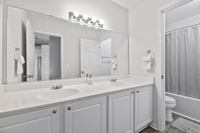 bathroom with shower / bath combo with shower curtain, a sink, toilet, and double vanity