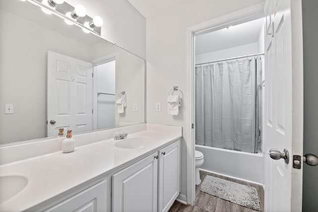 bathroom with toilet, shower / tub combo, wood finished floors, and vanity