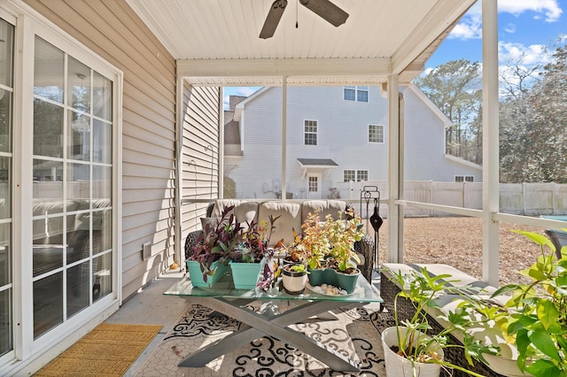 sunroom / solarium featuring a wealth of natural light and a ceiling fan