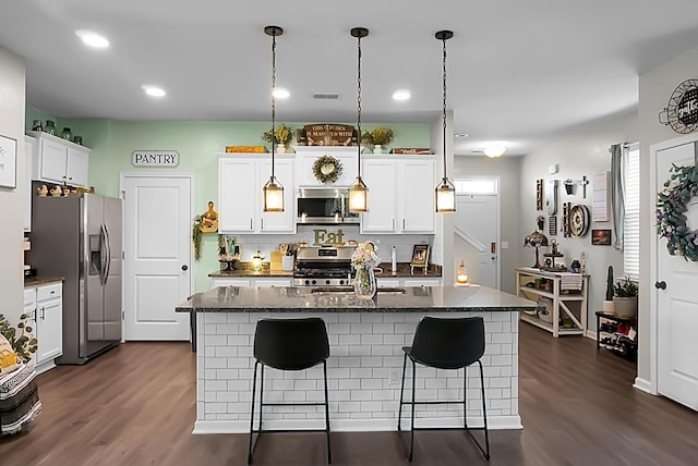 508 Glady Rd, Moncks Corner, SC 29461 - kitchen featuring stainless steel appliances, dark wood finished floors, a breakfast bar, white cabinets, and pendant lighting