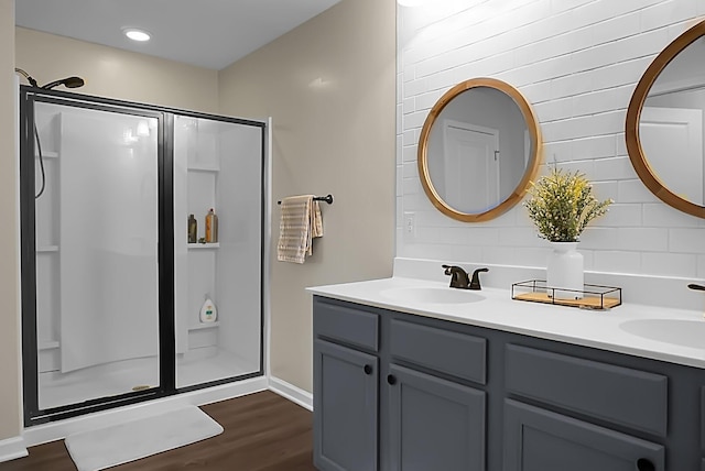 508 Glady Rd, Moncks Corner, SC 29461 - bathroom with a stall shower, backsplash, double vanity, wood finished floors, and recessed lighting