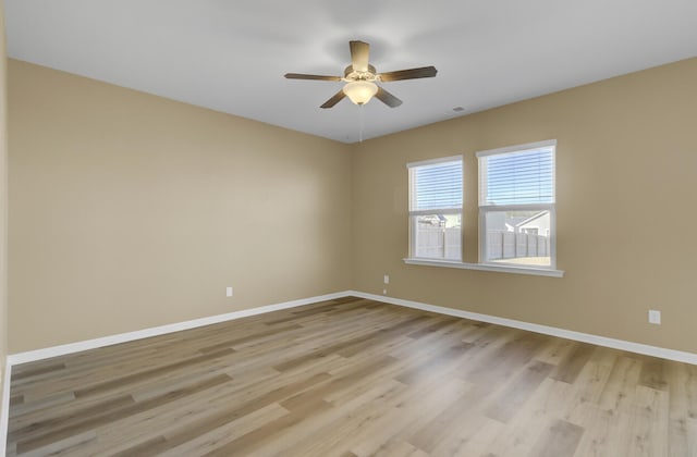 empty room featuring ceiling fan and light wood-type flooring