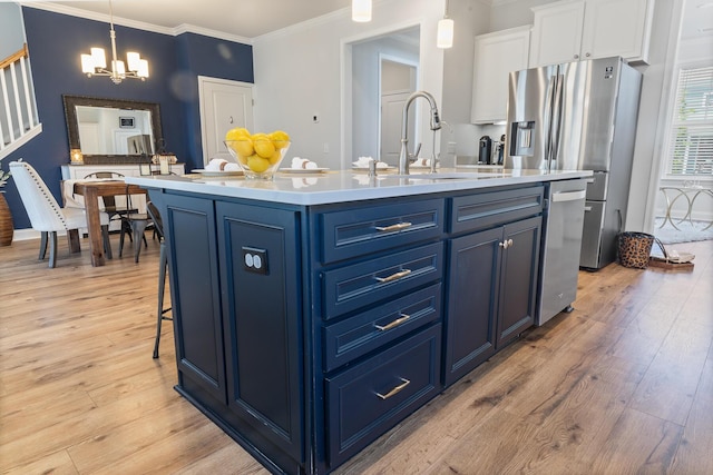 403 Cool Bend Ln, Summerville, SC 29486 - kitchen featuring blue cabinetry, a sink, a chandelier, ornamental molding, and appliances with stainless steel finishes