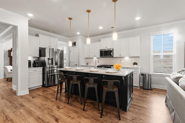 403 Cool Bend Ln, Summerville, SC 29486 - kitchen featuring appliances with stainless steel finishes, wood finished floors, a breakfast bar area, light countertops, and decorative backsplash