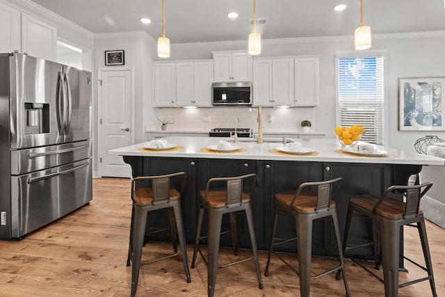 403 Cool Bend Ln, Summerville, SC 29486 - kitchen featuring stainless steel appliances, light wood-style flooring, light countertops, white cabinets, and ornamental molding
