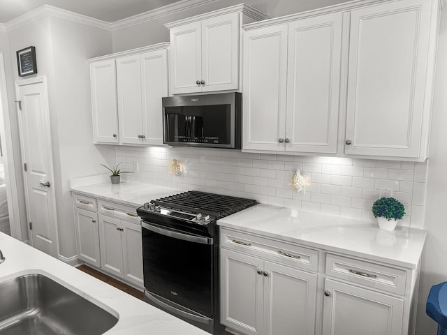 403 Cool Bend Ln, Summerville, SC 29486 - kitchen featuring black gas range oven, stainless steel microwave, white cabinets, backsplash, and a sink