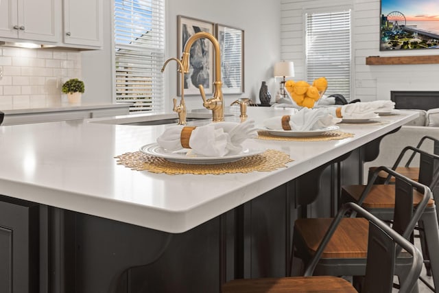 403 Cool Bend Ln, Summerville, SC 29486 - kitchen with a breakfast bar area, open floor plan, light countertops, and backsplash