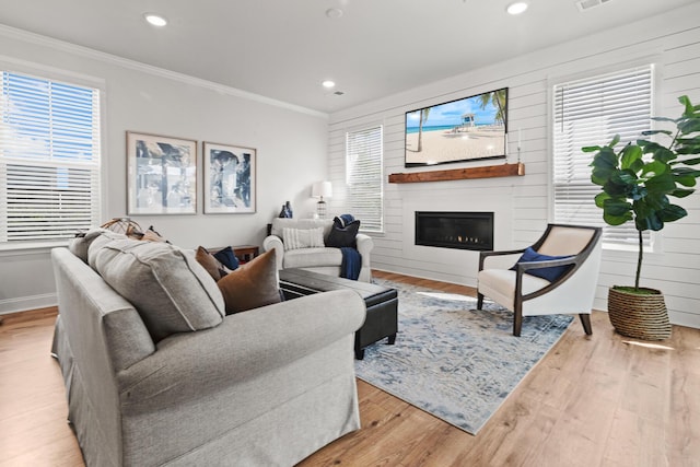 403 Cool Bend Ln, Summerville, SC 29486 - living area featuring crown molding, healthy amount of natural light, a glass covered fireplace, wood finished floors, and recessed lighting
