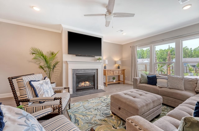 3173 Hugh Bennett Dr, Johns Island, SC 29455 - living room featuring ceiling fan, baseboards, wood finished floors, a fireplace with flush hearth, and ornamental molding
