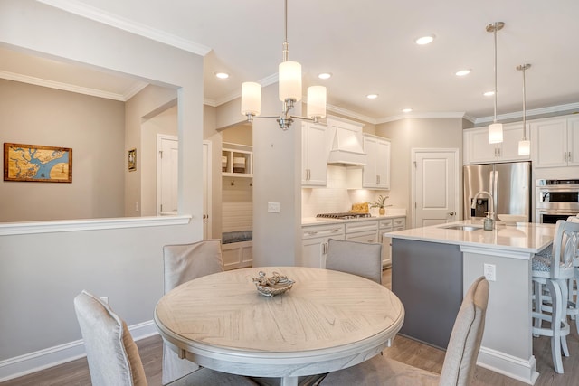 3173 Hugh Bennett Dr, Johns Island, SC 29455 - dining area featuring dark wood-type flooring, crown molding, recessed lighting, and baseboards