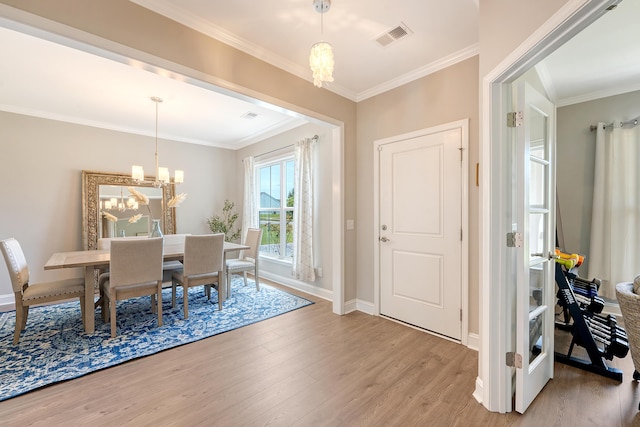 3173 Hugh Bennett Dr, Johns Island, SC 29455 - dining space with a chandelier, light wood-type flooring, crown molding, and baseboards