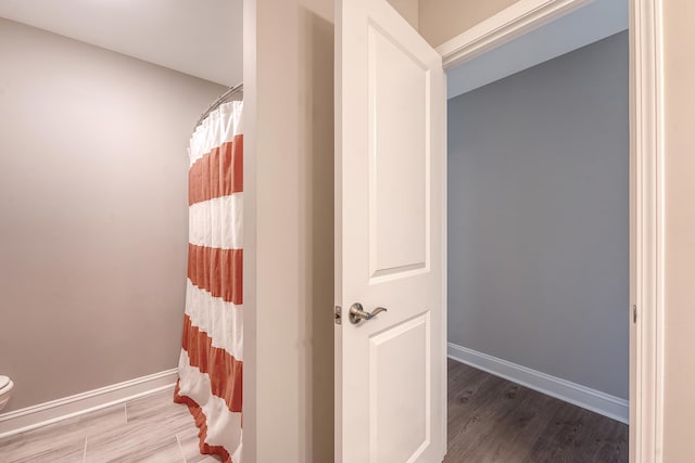 3173 Hugh Bennett Dr, Johns Island, SC 29455 - full bath featuring wood finished floors, toilet, baseboards, and a shower with curtain