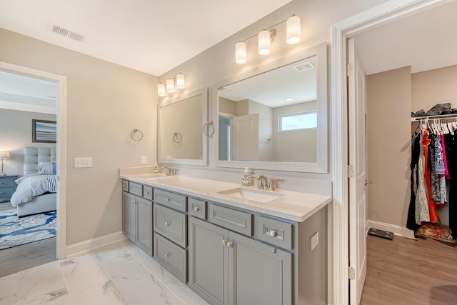 3173 Hugh Bennett Dr, Johns Island, SC 29455 - bathroom with baseboards, double vanity, ensuite bath, a spacious closet, and marble finish flooring