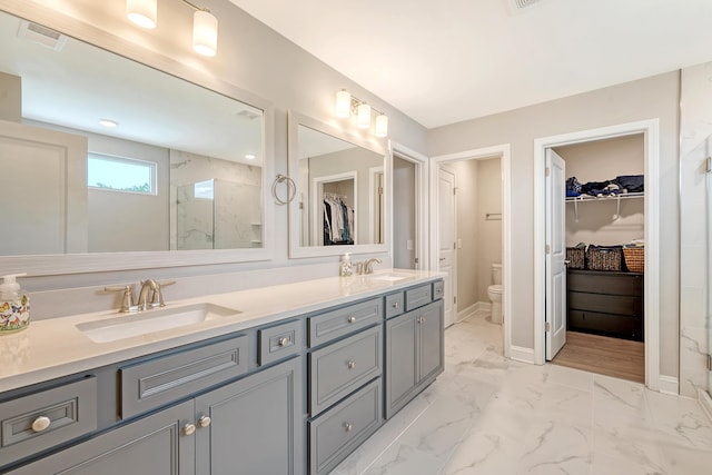 3173 Hugh Bennett Dr, Johns Island, SC 29455 - bathroom featuring toilet, marble finish floors, a stall shower, double vanity, and a walk in closet