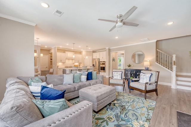 3173 Hugh Bennett Dr, Johns Island, SC 29455 - living room with ornamental molding, a ceiling fan, light wood-type flooring, recessed lighting, and stairs